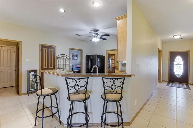 a view of two chairs and a chandelier in a room