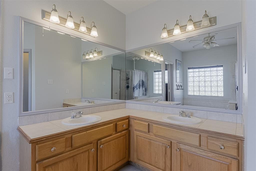 2403 Greathouse Road Waxahachie, TX 75167 - Photo 15 of 34 a bathroom with a sink double vanity granite and a mirror