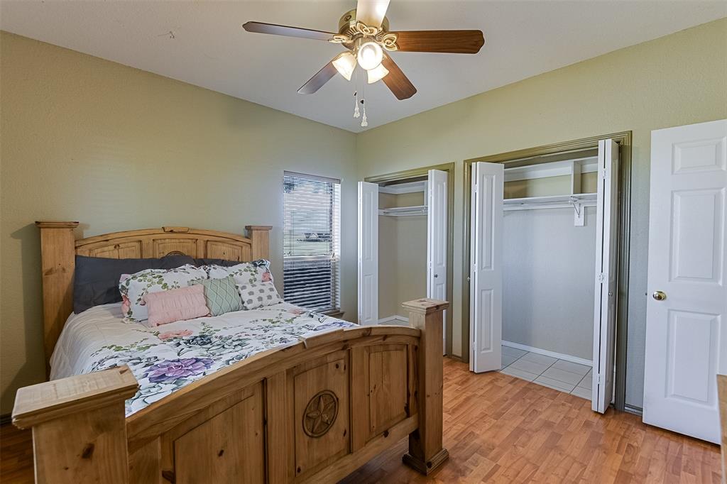 2403 Greathouse Road Waxahachie, TX 75167 - Photo 17 of 34 a bedroom with a bed and a chandelier