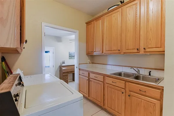 a kitchen with stainless steel appliances granite countertop a sink a stove and white cabinets