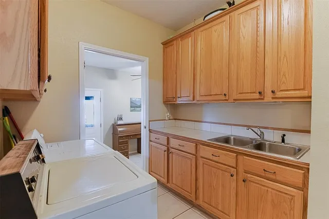 a kitchen with stainless steel appliances granite countertop a sink a stove and white cabinets
