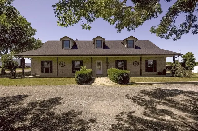 a front view of a house with a garden and porch