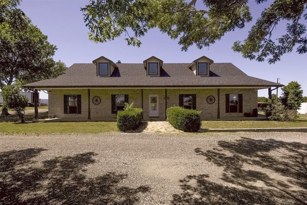 2403 Greathouse Road Waxahachie, TX 75167 - Photo 2 of 34 a front view of a house with a garden and porch