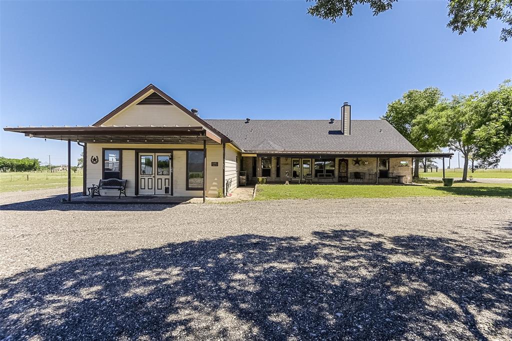 2403 Greathouse Road Waxahachie, TX 75167 - Photo 22 of 34 a front view of a house with a garden and patio