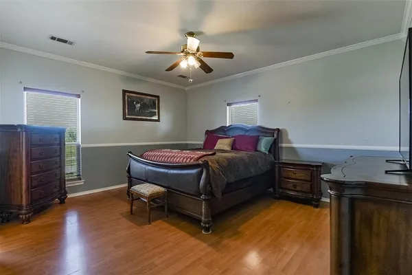 a bedroom with a bed and a chandelier