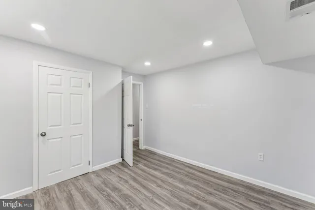 an empty room with wooden floor