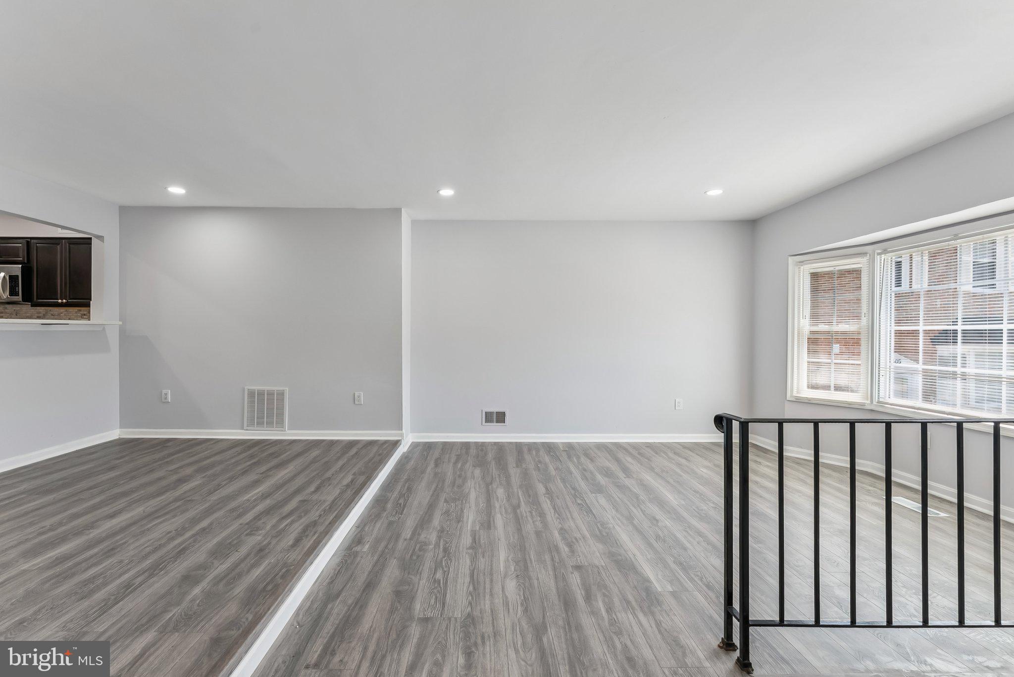 11400 Cosca Park Place Clinton, MD 20735 - Photo 4 of 22 an empty room with wooden floor and windows
