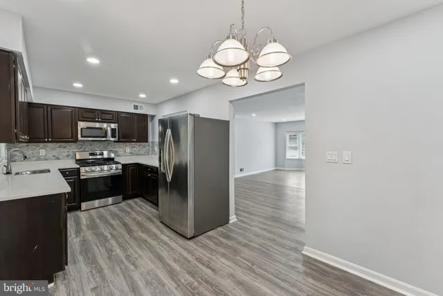 a kitchen with a refrigerator and a sink
