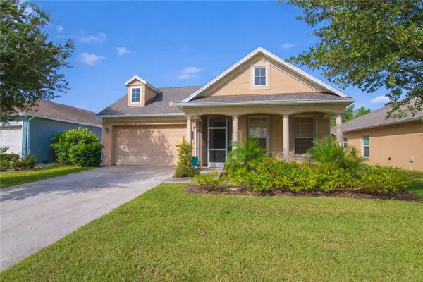 a front view of a house with a yard and porch