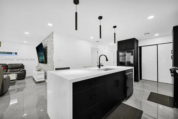 a kitchen with a sink and refrigerator