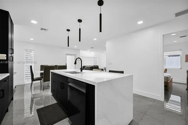 a kitchen with stainless steel appliances a sink stove and cabinets