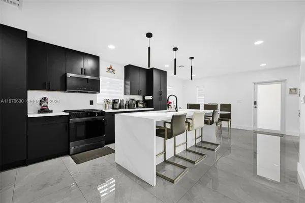 a kitchen with a refrigerator and a stove top oven