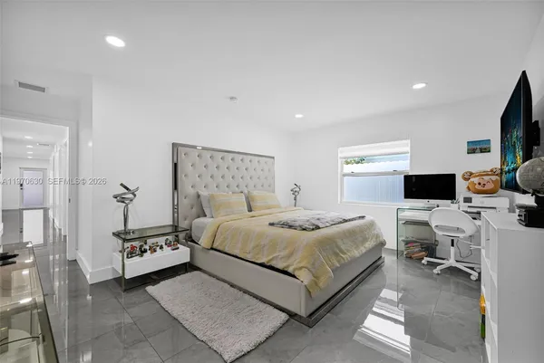 a bedroom with a large bed and a couch
