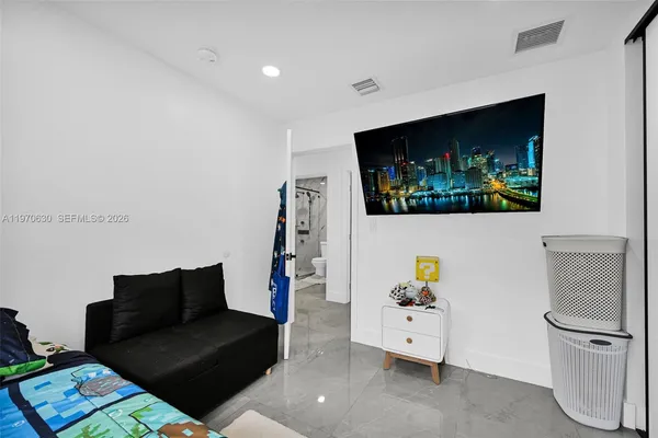a bedroom with a bed and a television