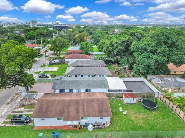 an aerial view of residential houses with outdoor space and street view