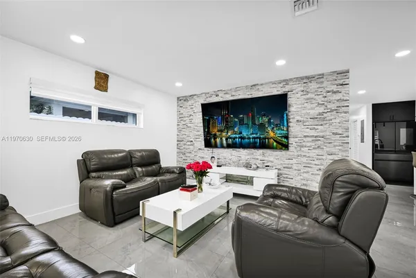 a living room with furniture and a flat screen tv