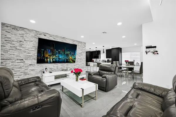 a living room with furniture and a flat screen tv