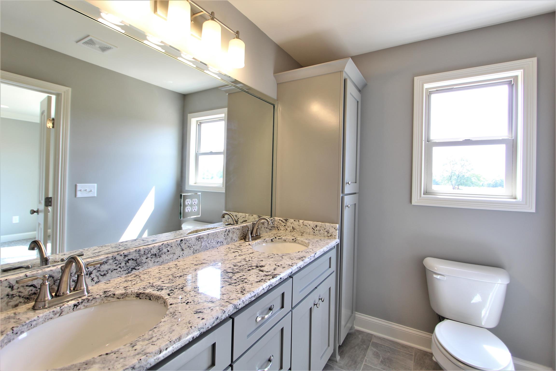 6620 Murfreesboro Road, Unit 29 Lebanon, TN 37090 - Photo 17 of 23 a bathroom with a granite countertop toilet a sink and a mirror