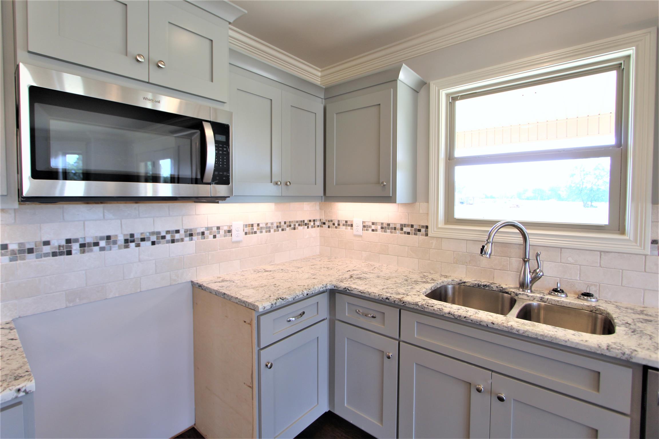 6620 Murfreesboro Road, Unit 29 Lebanon, TN 37090 - Photo 8 of 23 a kitchen with stainless steel appliances granite countertop a sink and a microwave