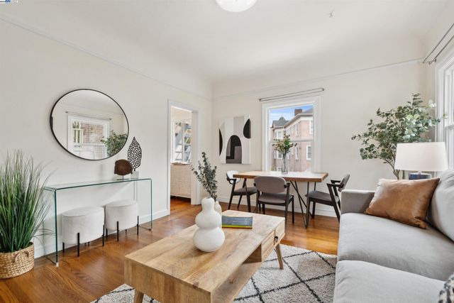 a living room with furniture a large window and a potted plant