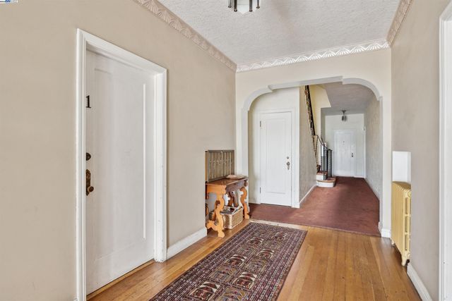 a view of a hallway view with wooden floor and furniture