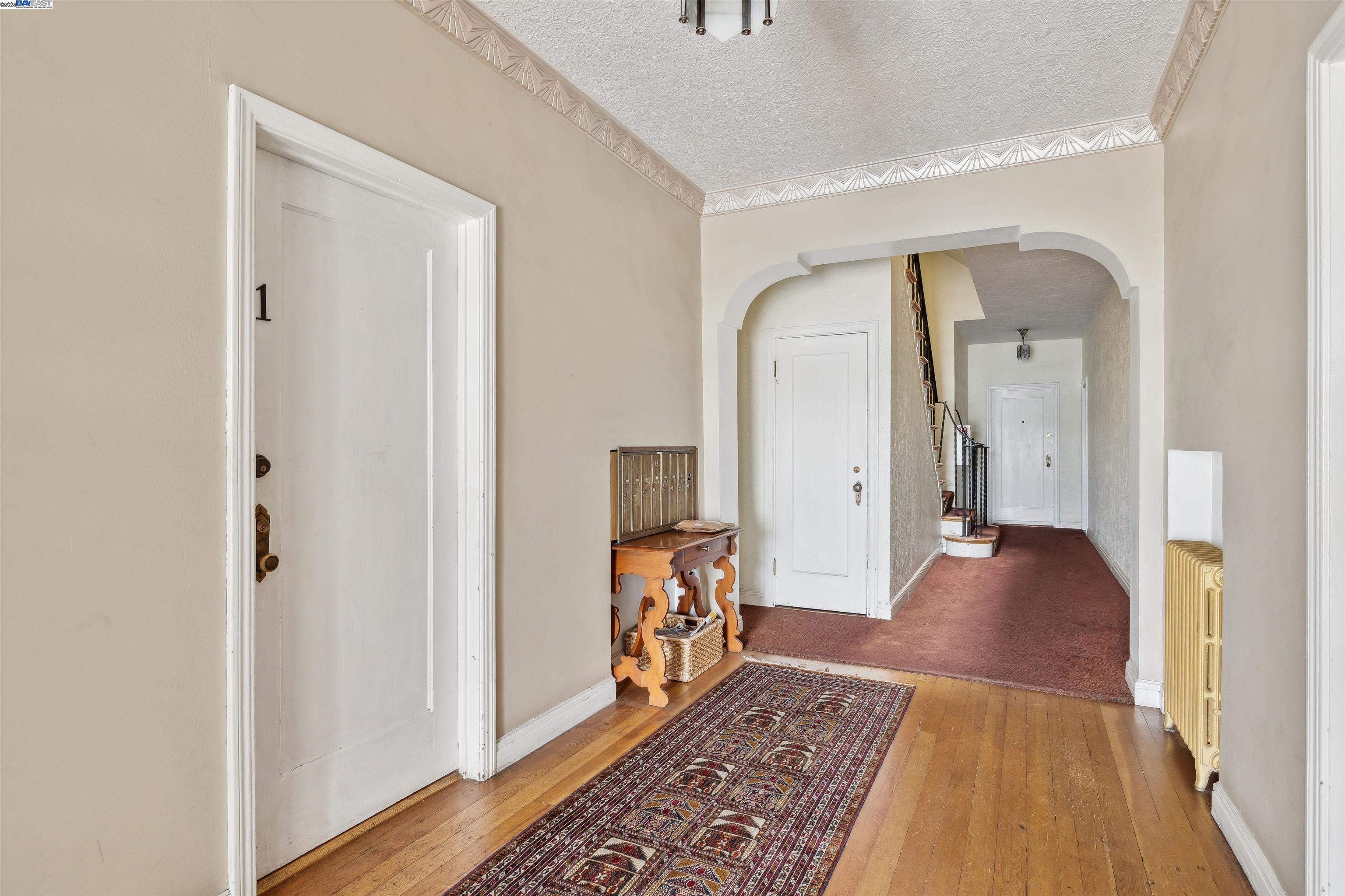 1438 Lakeshore Avenue, Unit 6 Oakland, CA 94606 - Photo 5 of 21 a view of a hallway view with wooden floor and furniture
