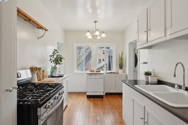 a kitchen with a sink stove and cabinets