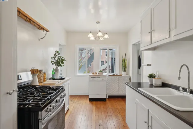 a kitchen with a sink stove and cabinets