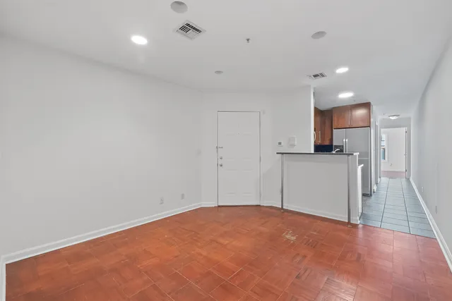 a view of a kitchen with a sink and a refrigerator