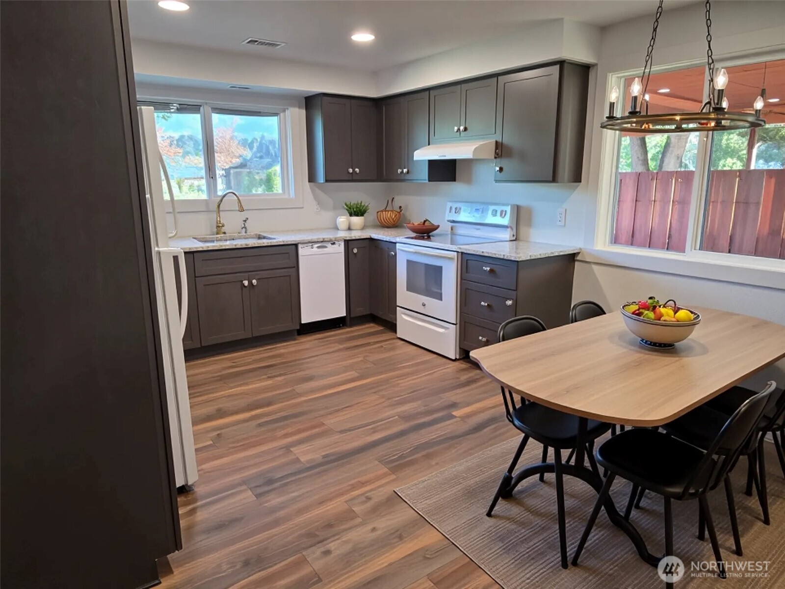 620 North Street Monroe, WA 98272 - Photo 5 of 38 a kitchen with a sink a window a dining table and chairs