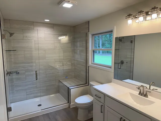 a bathroom with a sink toilet and shower