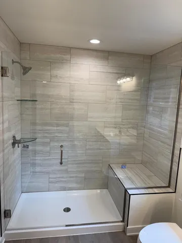 a bathroom with a shower and a toilet