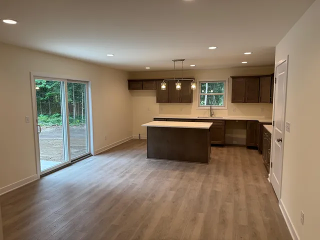a view of kitchen with wooden floor and electronic appliances
