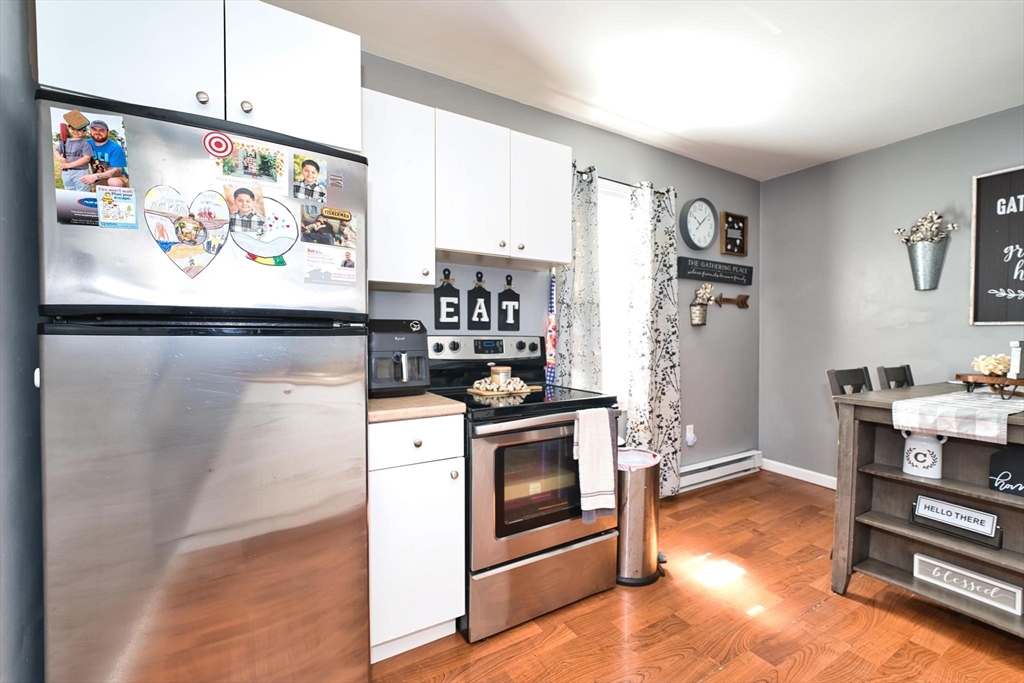 232 Alden Street Fall River, MA 02723 - Photo 29 of 34 a kitchen with stainless steel appliances kitchen island granite countertop a refrigerator and a stove top oven
