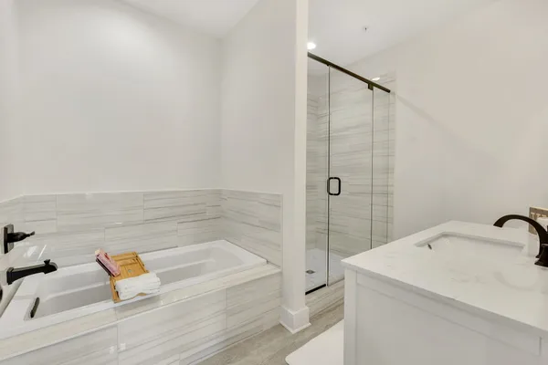 a bathroom with a tub and shower