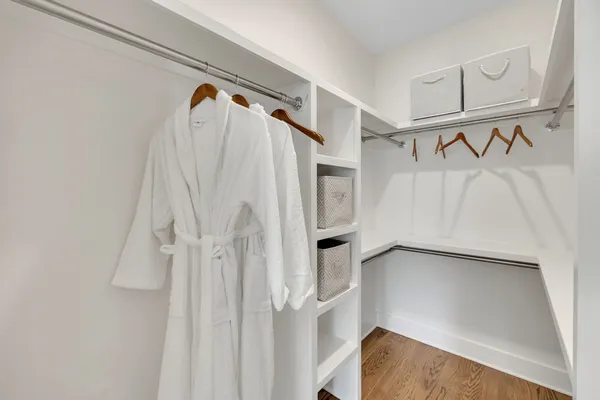 a view of walk in closet with empty racks