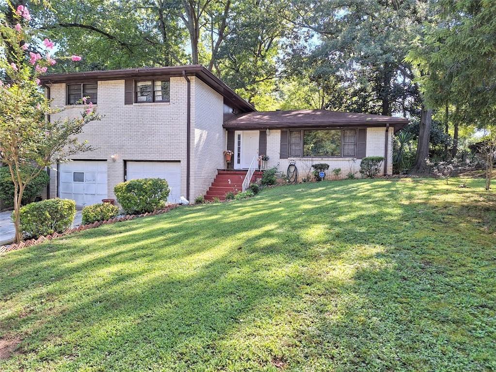 a front view of a house with a garden and trees