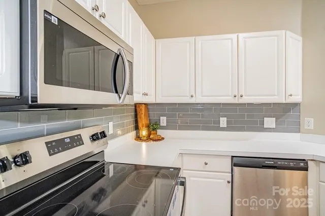 a kitchen with a stove and a microwave