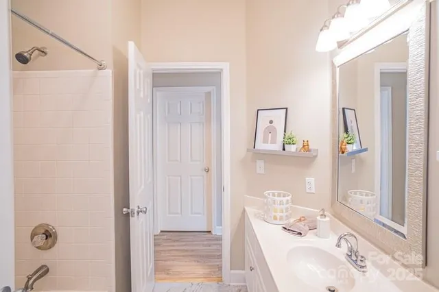 a bathroom with a tub sink and mirror