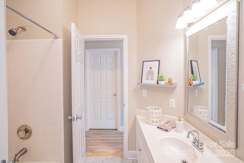 1125 Torrence Circle Davidson, NC 28036 - Photo 24 of 41 a bathroom with a tub sink and mirror
