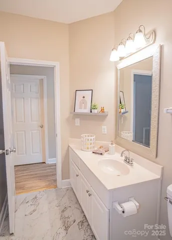 a bathroom with a sink vanity and a mirror