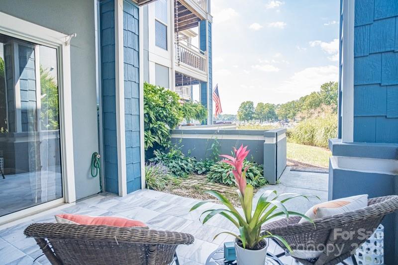 1125 Torrence Circle Davidson, NC 28036 - Photo 29 of 41 a vase of flowers sitting on a table in front of a window