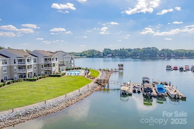 a view of a lake with couches chairs and a table