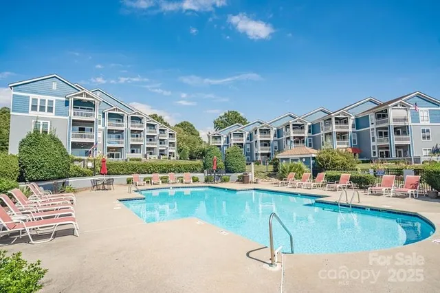 a swimming pool with outdoor seating and yard