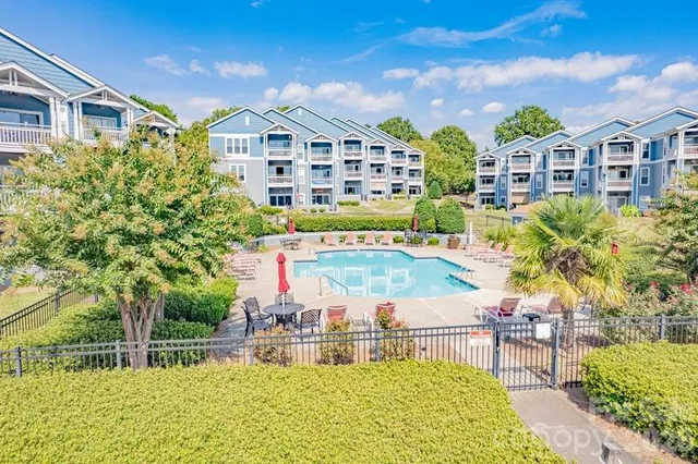 a view of a building with a garden and sitting area