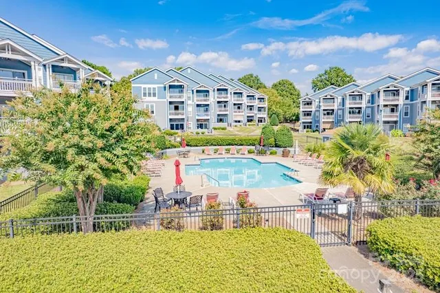 a view of a building with a garden and sitting area