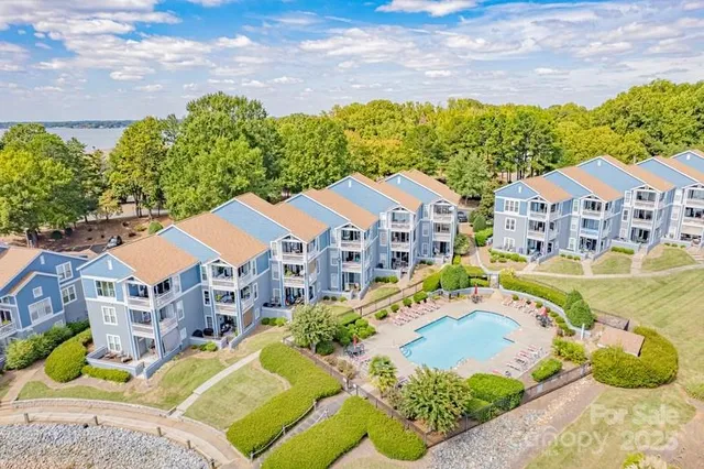 a aerial view of a house with a big yard and large trees