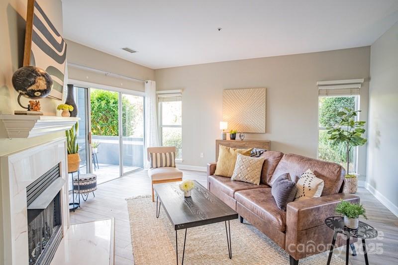 1125 Torrence Circle Davidson, NC 28036 - Photo 5 of 41 a living room with furniture fireplace and a large window