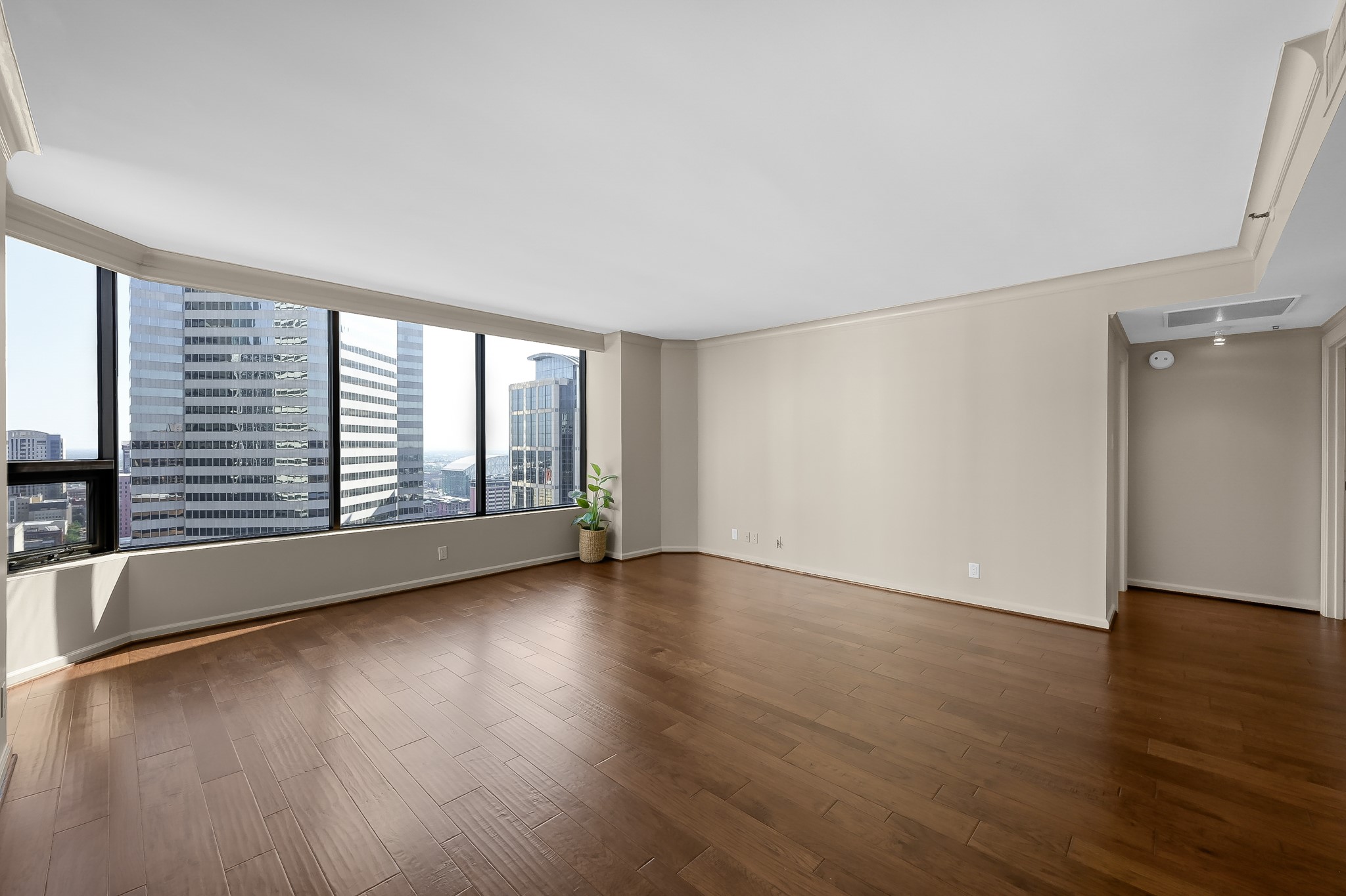 1111 Caroline Street, Unit 2901 Houston, TX 77010 - Photo 11 of 46 an empty room with wooden floor and windows