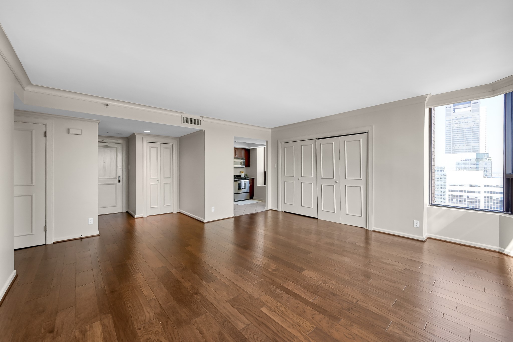 1111 Caroline Street, Unit 2901 Houston, TX 77010 - Photo 12 of 46 an empty room with wooden floor and windows